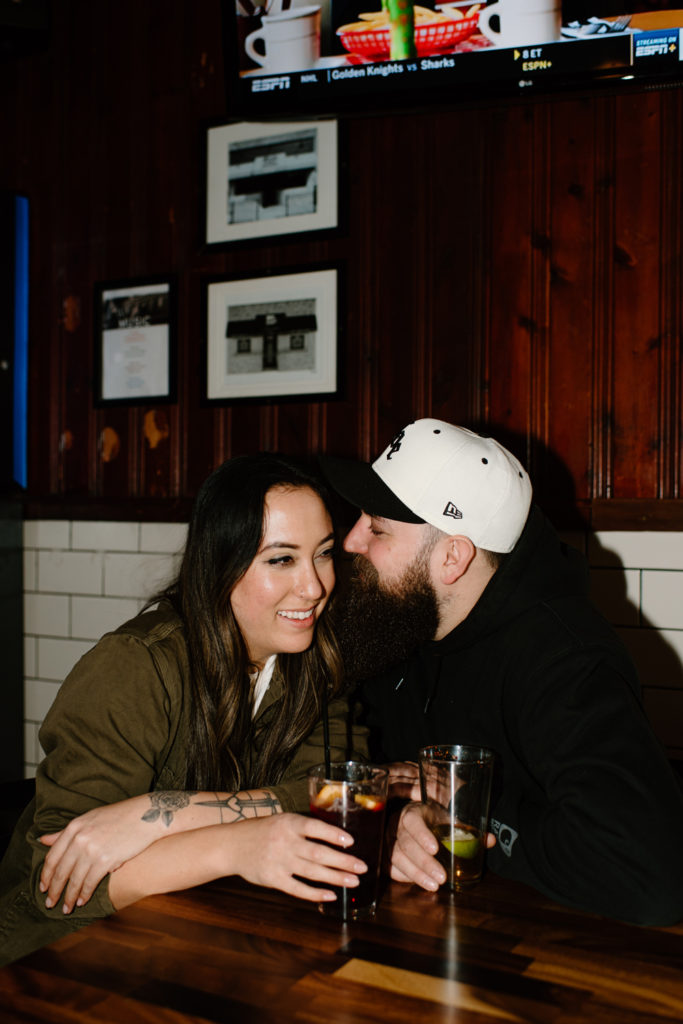 boyfriend and girlfriend enjoy time together at their favorite bar in town