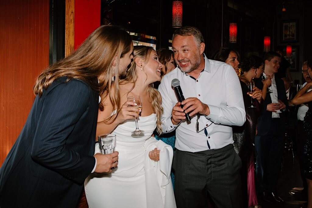 A guest sings with the bride and groom on their wedding day at a Chicago karaoke bar.