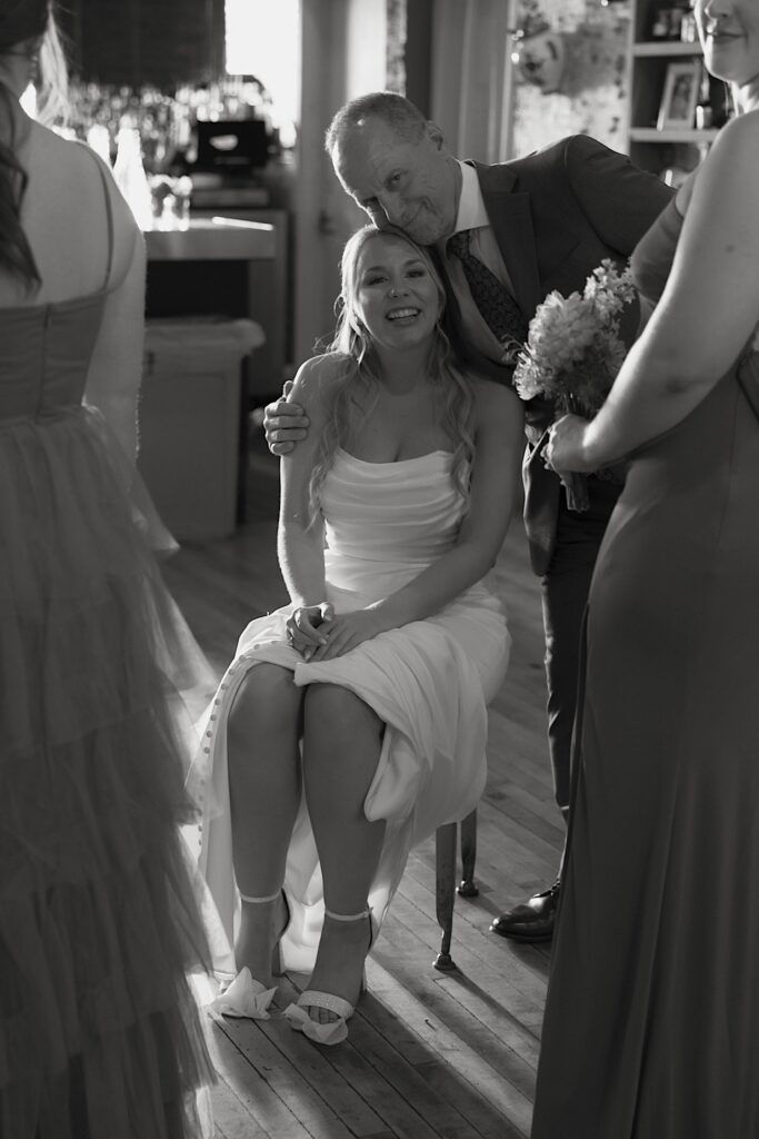 A bride poses for a quick photo with her dad before her Chicago wedding ceremony starts. 