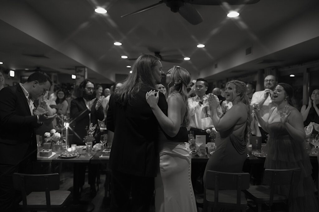 The bride and groom kiss during their wedding reception at Homestead on the Room in Chicago.